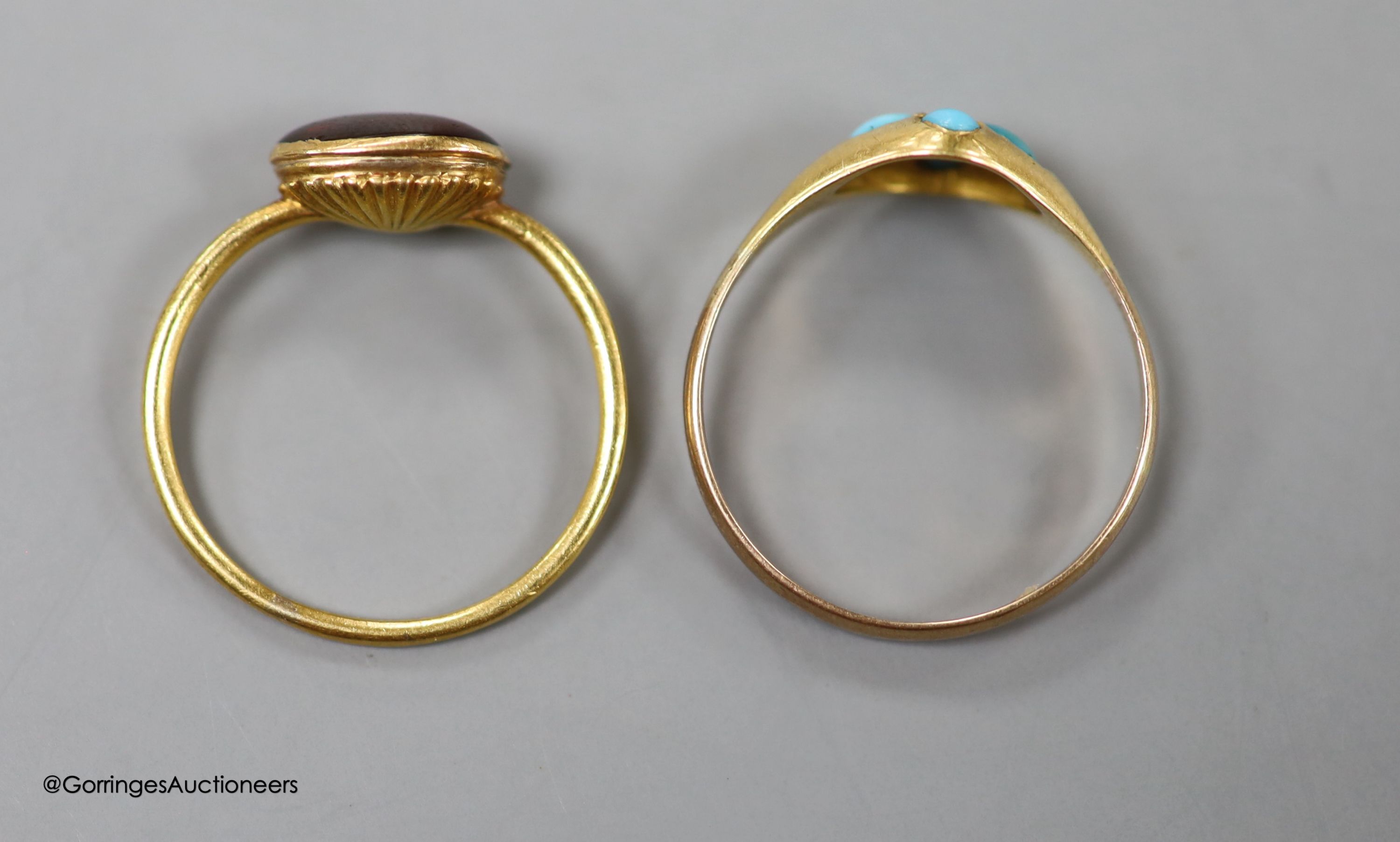 A 19th century yellow metal and gem set ring, size L, gross 1.8 grams and a later yellow metal and turquoise cluster set ring, size Q, gross 1.8 grams.